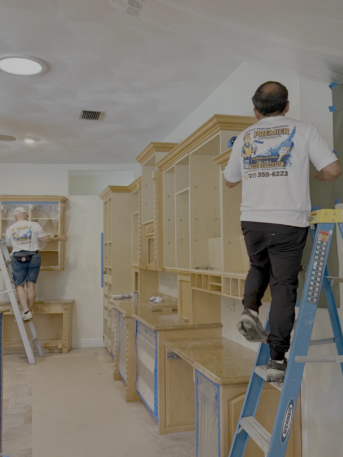 Premier Contractors FL crew prepping and masking kitchen cabinets in Tampa FL