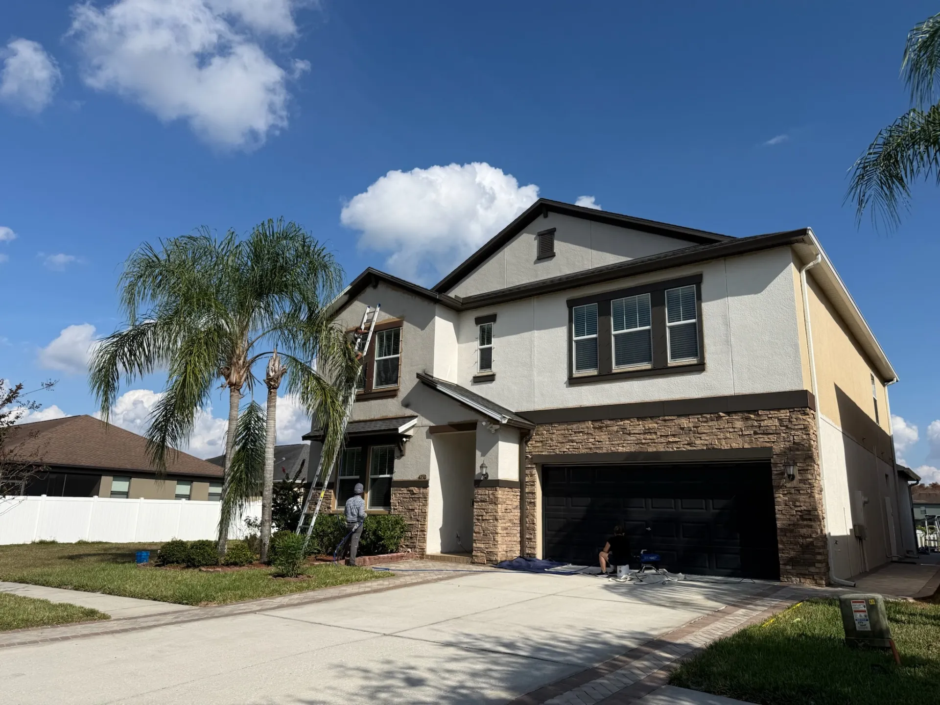 Two-story exterior painting in progress Lutz - Premier Contractors FL