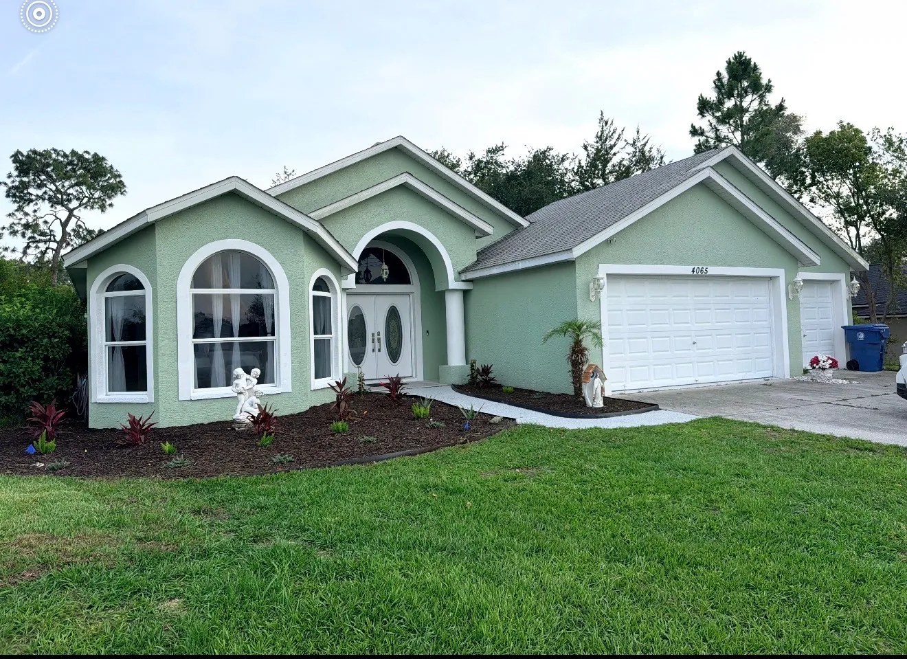 Sage green stucco home before exterior repaint in Tampa FL - Premier Contractors FL
